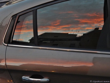 A Roma sunset trapped in a car.